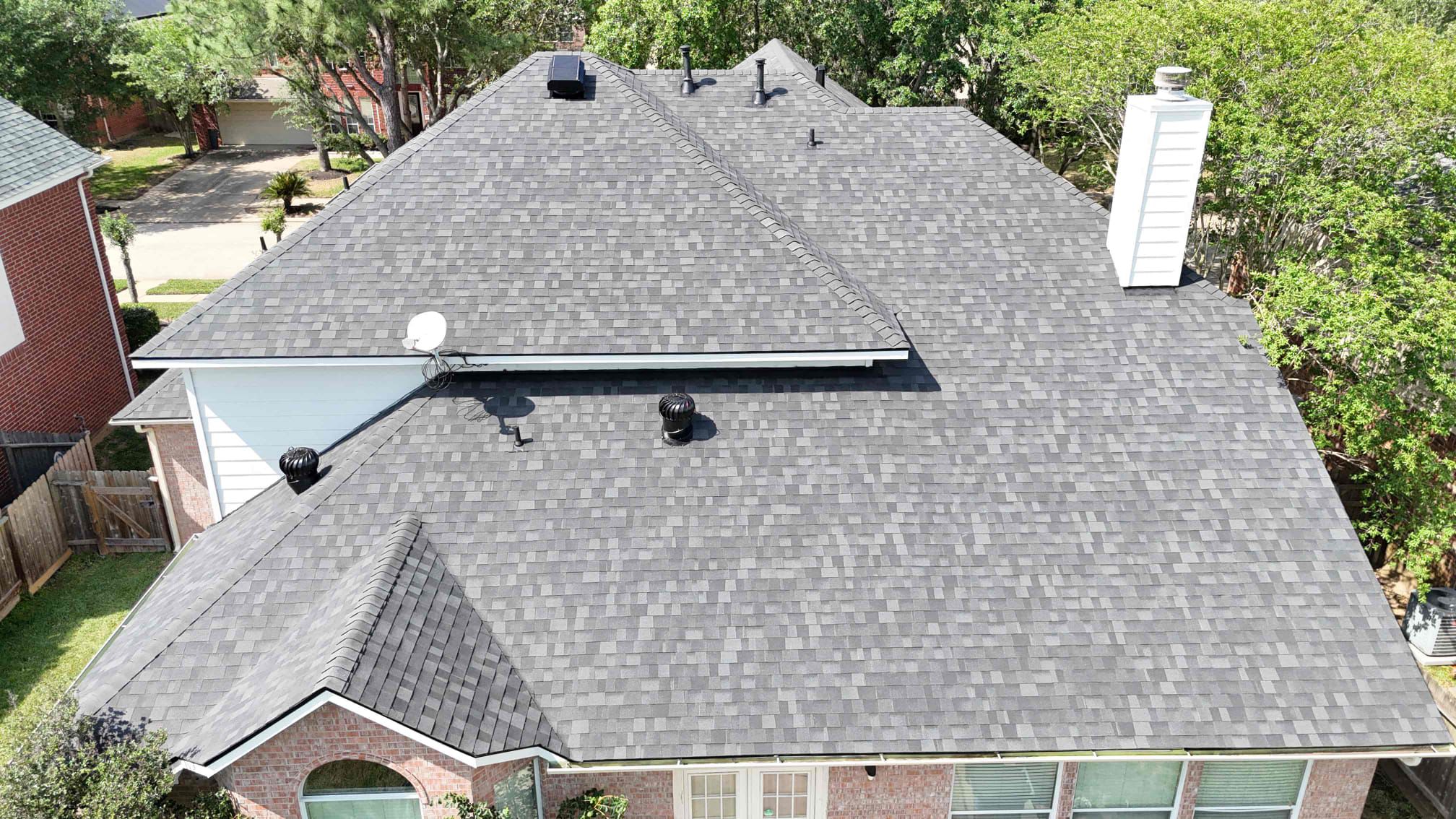 Tomball TX home showcasing a newly installed architectural shingle roof with updated black attic vents