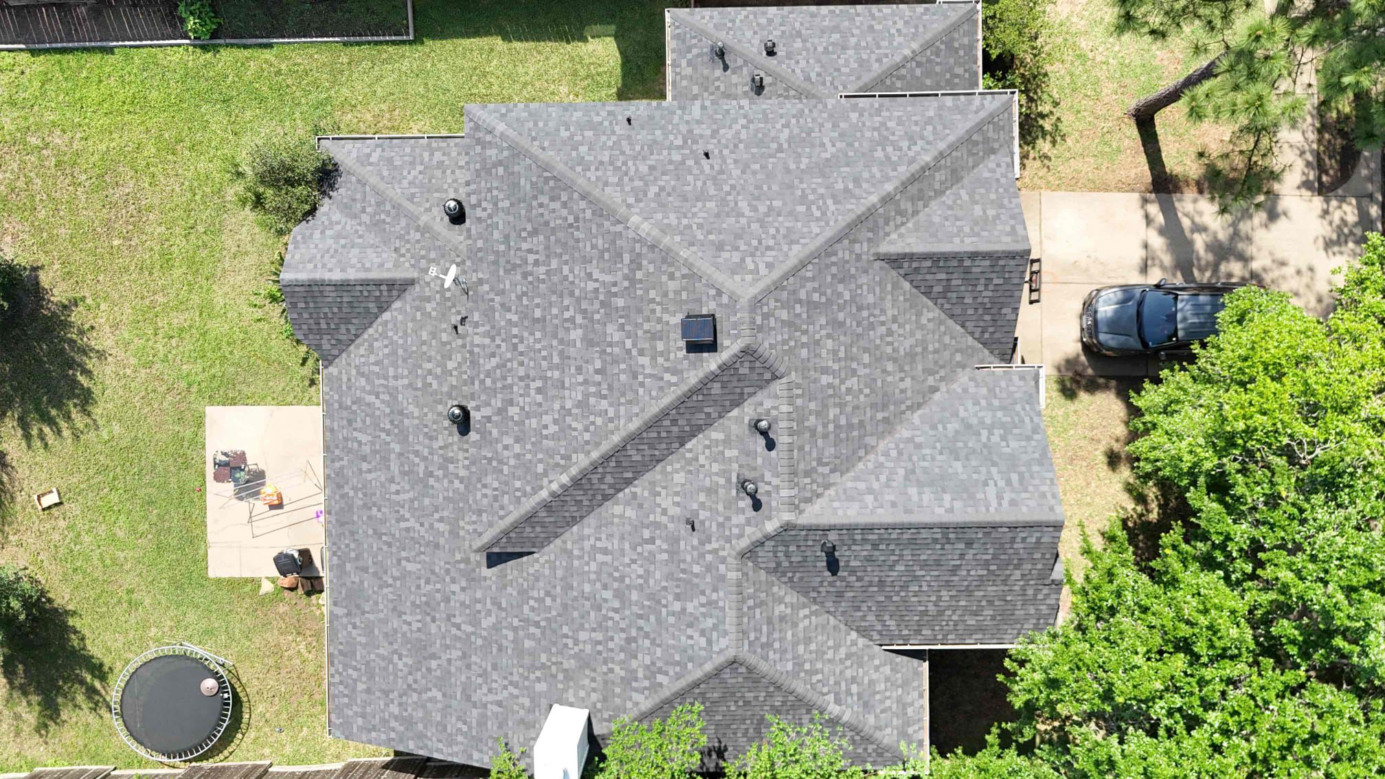 Completed architectural shingle roof and attic ventilation installation on a home in Tomball TX