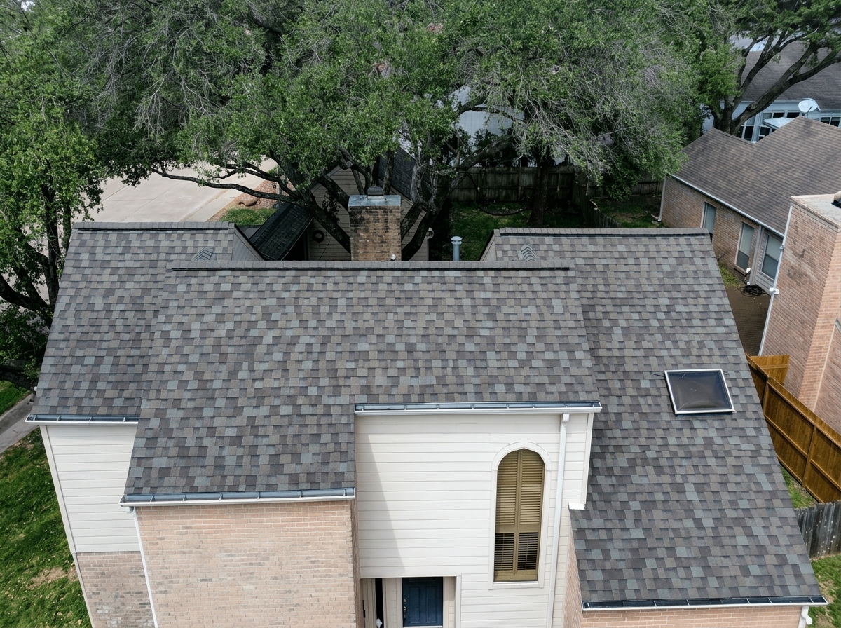 A multi-story brick and white siding home showcasing its newly installed architectural shingle roof after a successful inspection in Spring TX